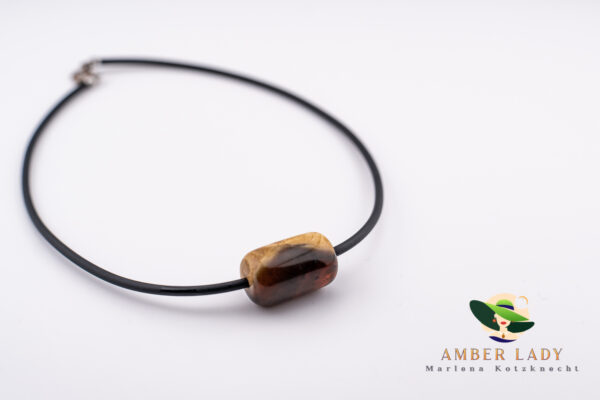Necklace with amber in the shape of a rod ,black jewelry cord.