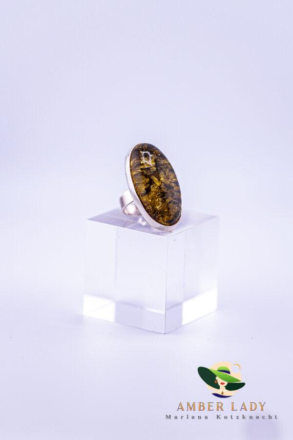Sterling silver ring with green amber.Lenght of amber 4,5 cm.